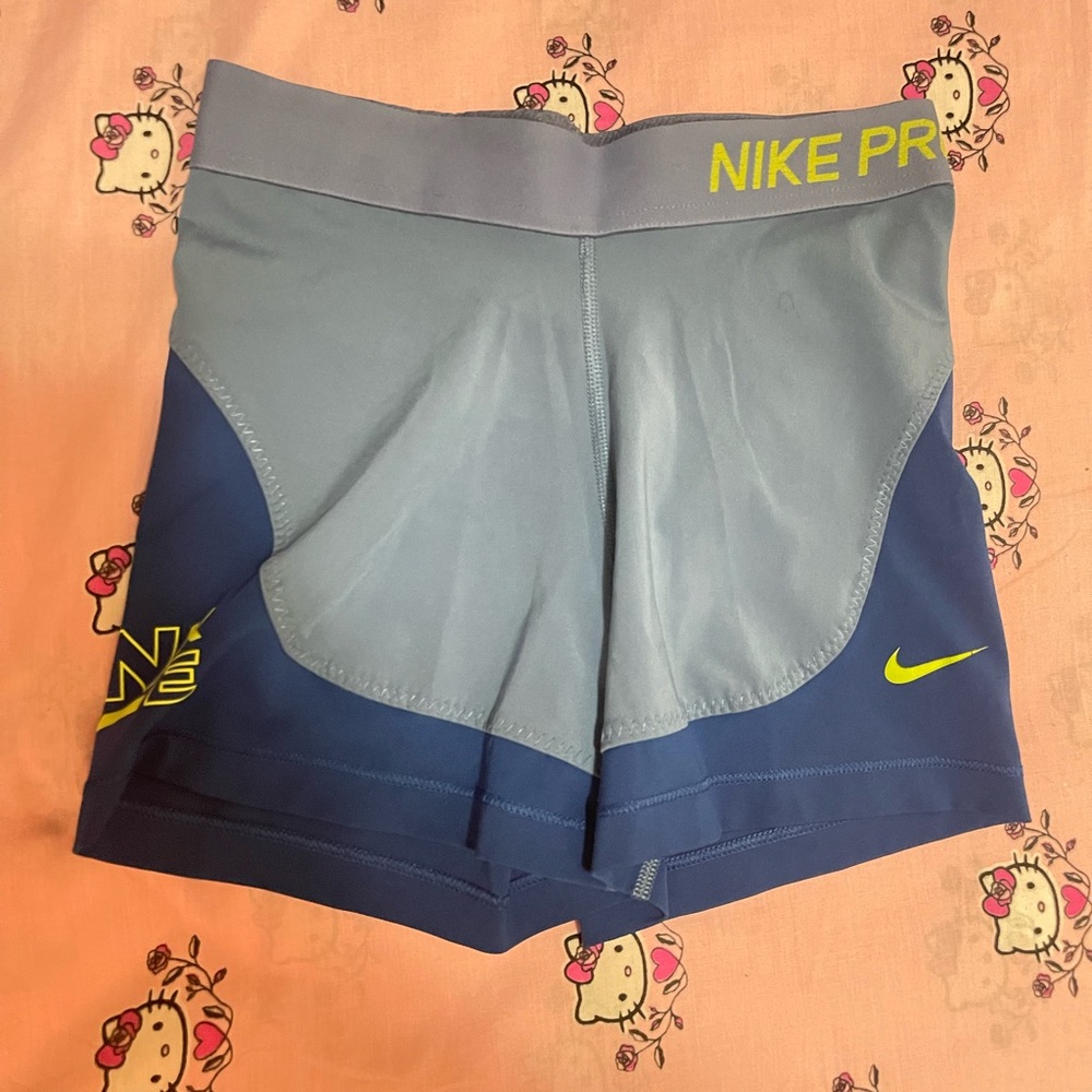 Blue color blocked Nike Pros with green detail